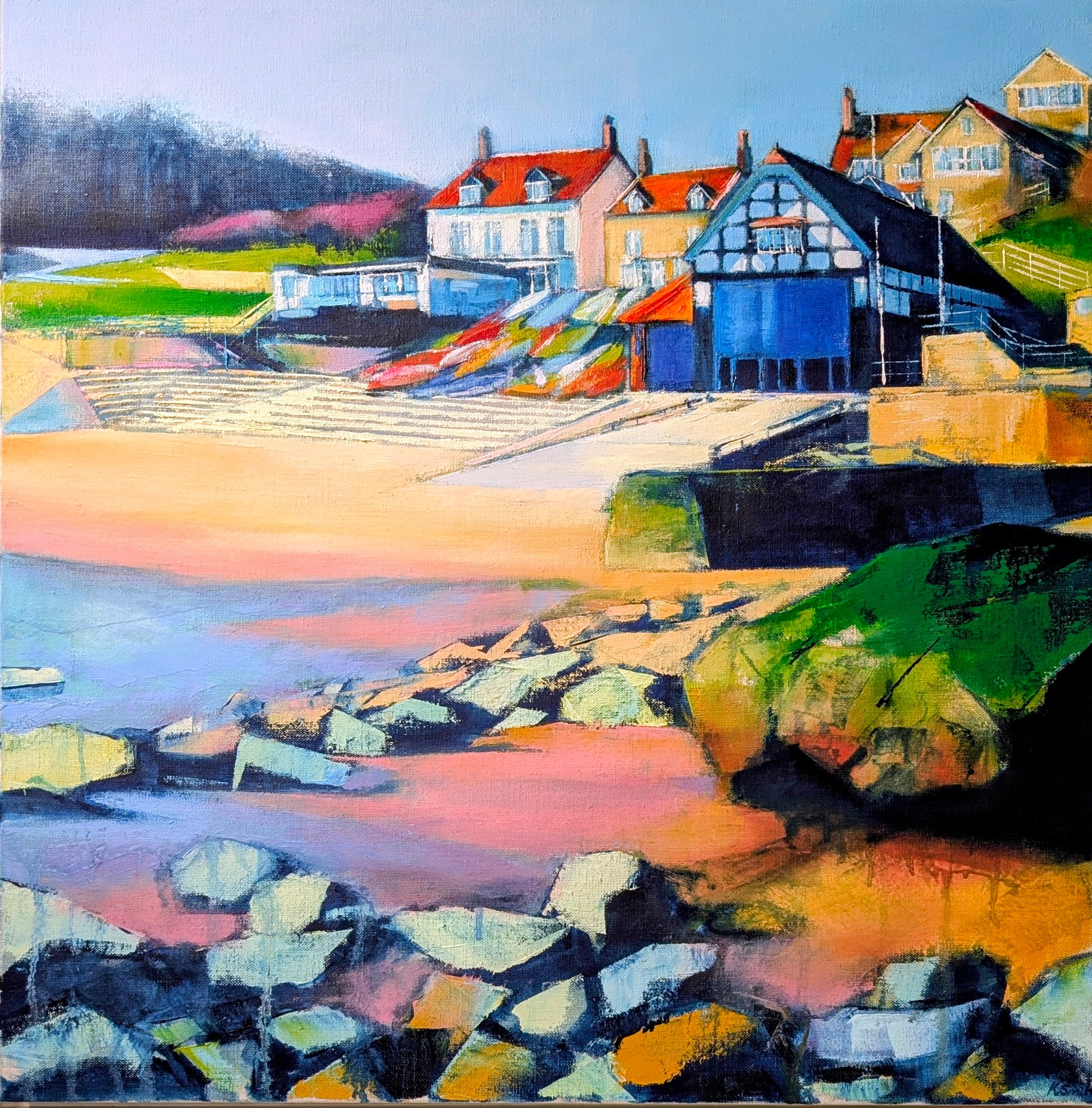 Colourful coastal scene with houses and a beach at Runswick Bay in North Yorkshire