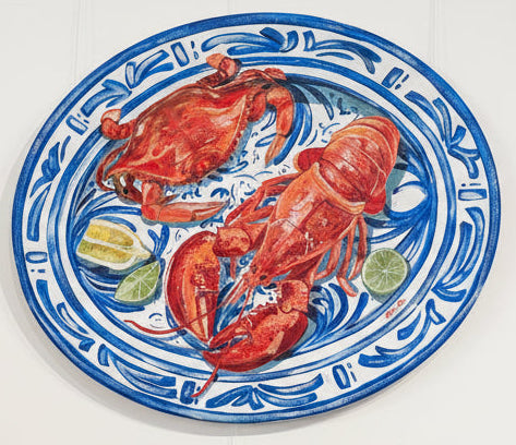 Decorative plates with lobster, crab and lemon of a delft style plate.